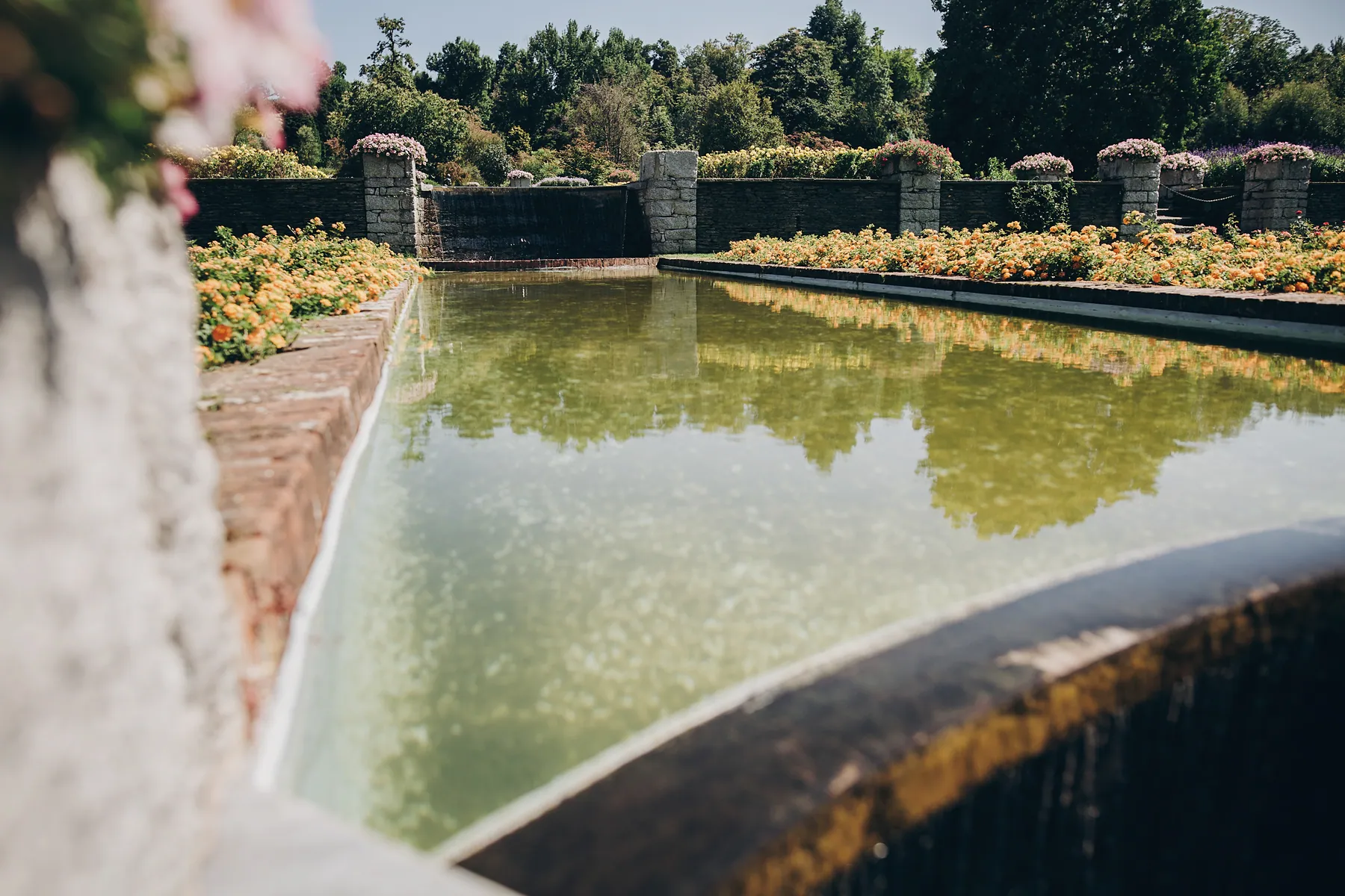 Mineralisch gebautes Wasserbecken mit Natursteinkante